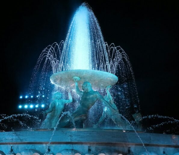 a group of people in a water fountain